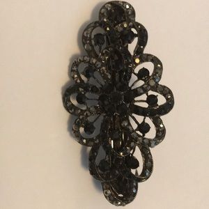 A black hair clip with black sequence.